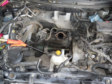 2006 Ford E350 - Close-up view of a vehicle's engine bay, showing mechanical components and wiring harnesses.