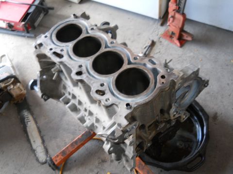 2006 Ford E350 - A disassembled engine block sits on a stand, with tools nearby.