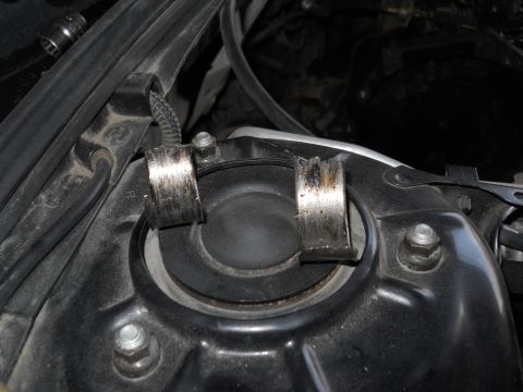 2006 Ford E350 - Close-up view of two damaged metal bearing components, likely from a vehicle's suspension system.