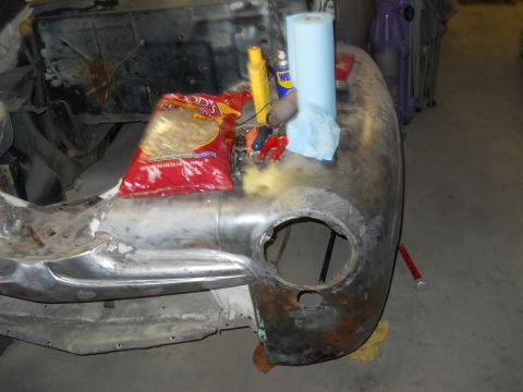 2006 Ford E350 - A vehicle's front end is undergoing repair, with tools and supplies laid out on the fender.