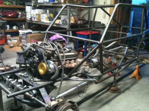 1966 Ford Bronco - Custom buggy frame with engine and suspension components in a garage setting.