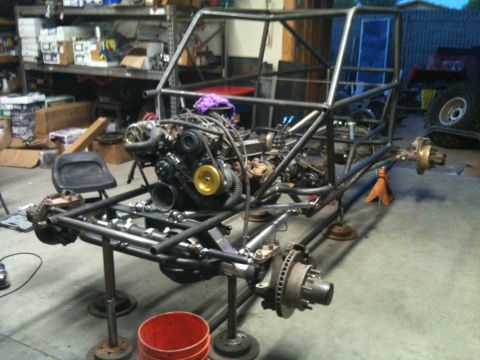 1966 Ford Bronco - This custom-built buggy frame is in a workshop, showing its engine and suspension parts.