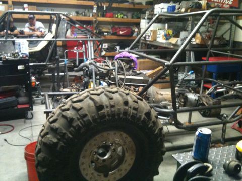 1966 Ford Bronco - Two custom off-road buggy frames are under construction in a workshop setting.