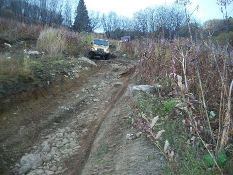 1979 Ford Bronco - Two Jeep Wranglers navigate a challenging off-road course on a cloudy day.