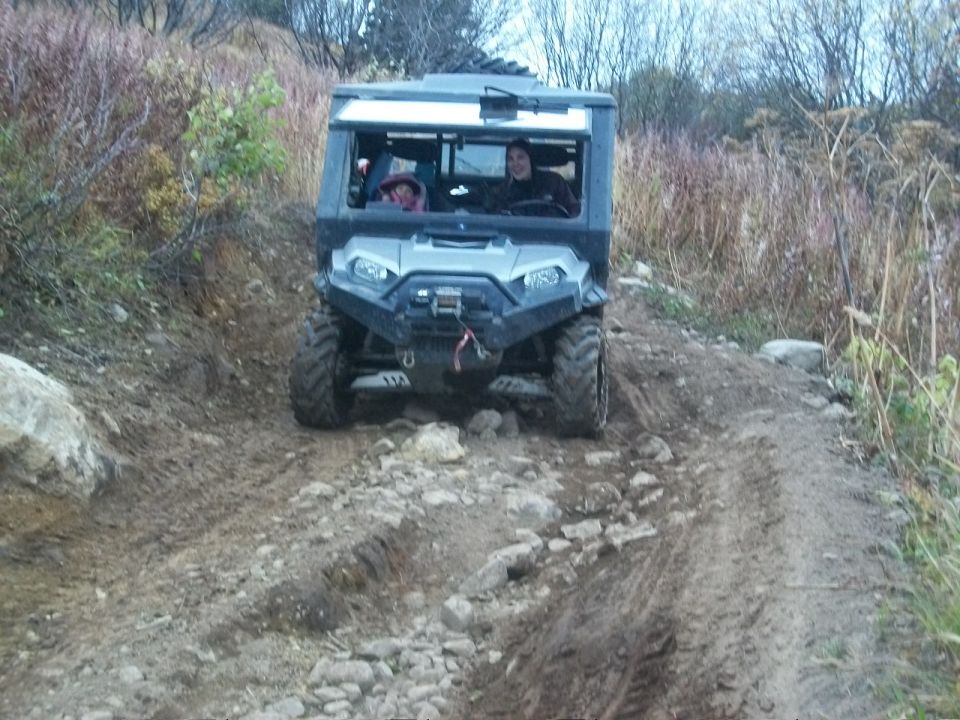 Gray all-terrain vehicle on a rocky, muddy trail