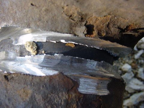 1992 Ford Bronco - This image shows a close-up of a corroded metal part, likely from a vehicle's undercarriage.