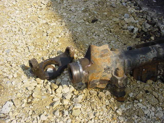 Driveshaft part on gravel. Supermotors.net logo visible