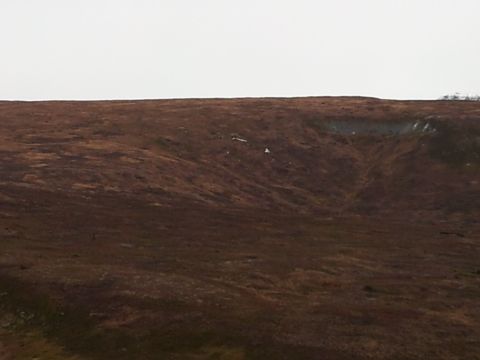 1990 Chevrolet Suburban - A wide view of a desolate landscape with brown, grassy hills and a bright, overcast sky.