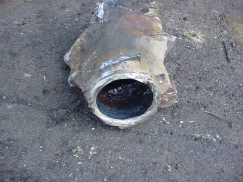 1992 Ford Bronco - This is a close-up of a rusted metal pipe fitting with a hole in one end.