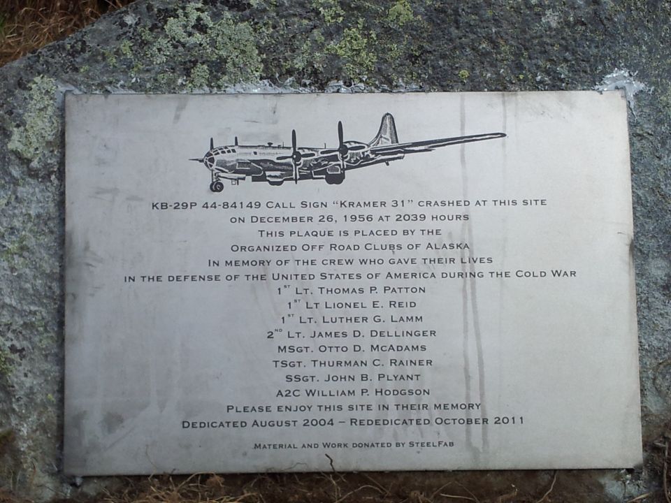 Plaque shows a B-29 bomber, lists crew names, and states it crashed on Dec 26, 1956