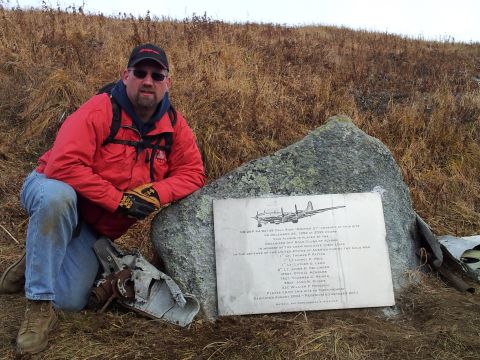 1990 Chevrolet Suburban - Memorial plaque at a crash site with a man and aircraft wreckage.