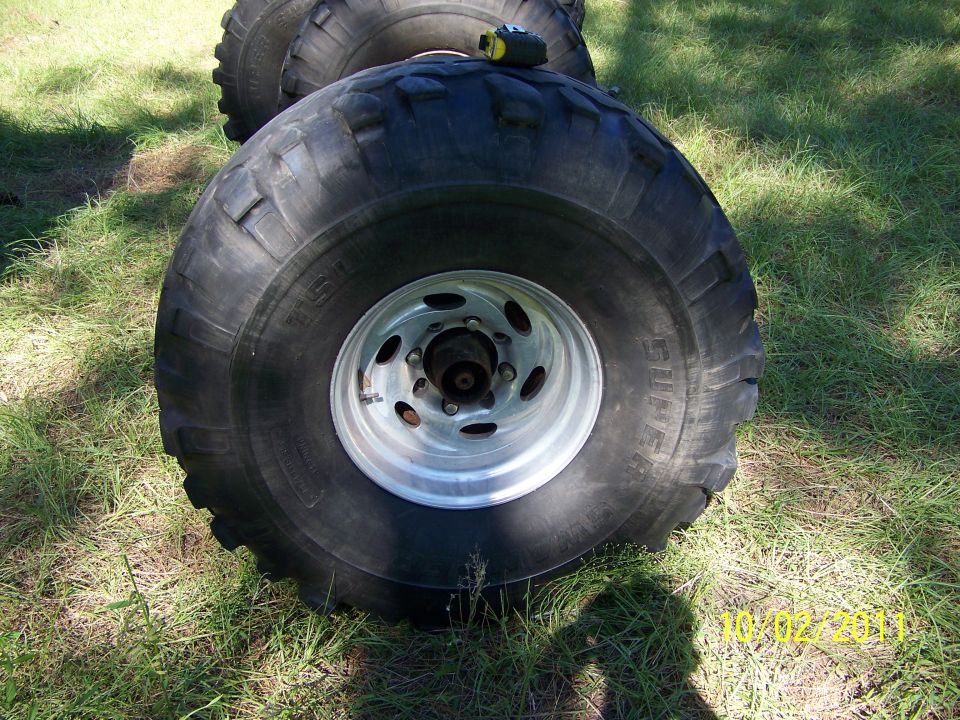 Oversized tires and rims on grass. Date stamp 10/02/2011