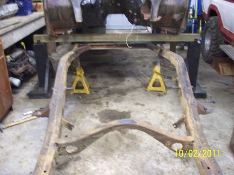 1990 Ford Bronco - Vehicle frame on jack stands, with a partial body above it. Date stamp shows 10/02/2011.