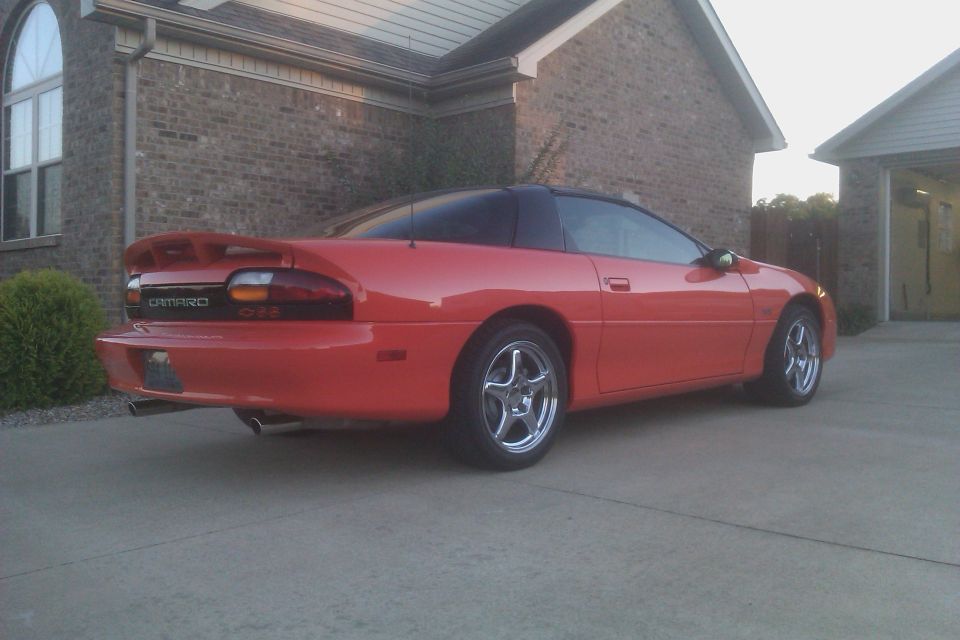 Red 1999 Chevrolet Camaro parked in driveway