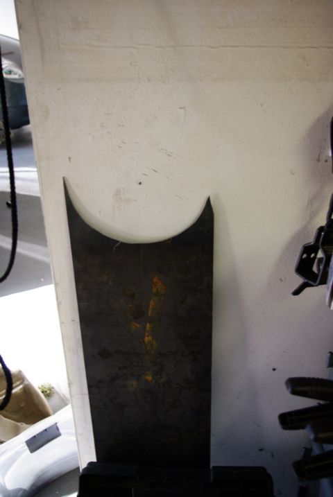 1995 Ford Bronco - A dark, curved metal panel with rust marks is shown leaning against a textured wall.