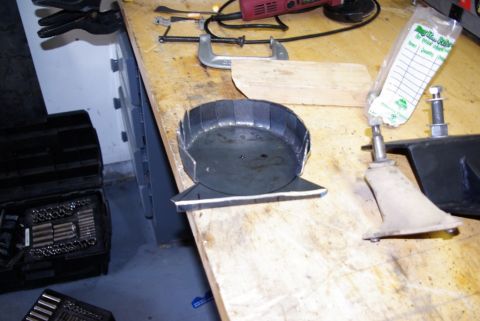1995 Ford Bronco - Metal parts and tools are laid out on a workbench, suggesting a DIY project.