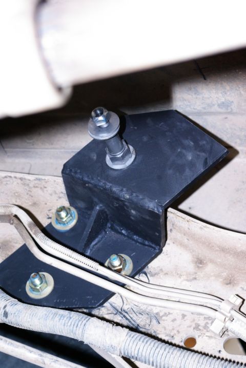 1995 Ford Bronco - This image shows a custom-fabricated bracket attached to the frame of a vehicle, likely for shock absorber mounting.