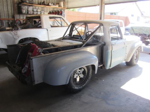 1987 Suzuki Samurai - Custom pickup truck with roll cage and modified bed, another white pickup in background.