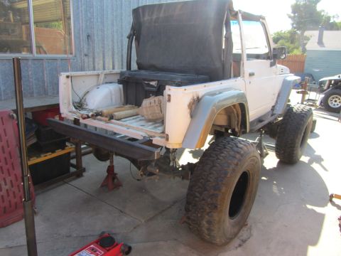1987 Suzuki Samurai - This 1987 Suzuki Samurai is shown from the rear, oversized tires and a soft top.