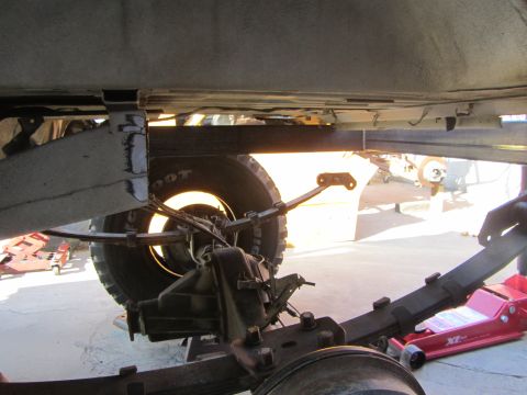 1987 Suzuki Samurai - Close-up view of a vehicle's rear suspension system, showing leaf springs and axle components.