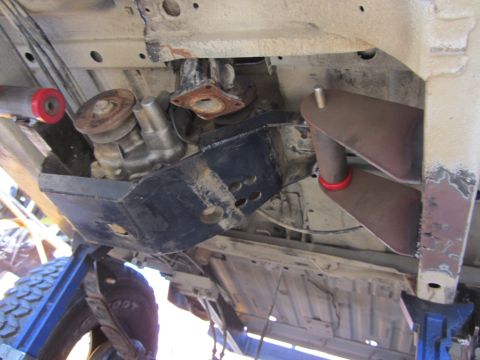 1987 Suzuki Samurai - Custom suspension and transfer case modifications are visible on the underbody of this vehicle.