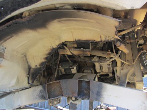 1987 Suzuki Samurai - Close-up view of a vehicle's undercarriage, showing mechanical parts and structural elements.