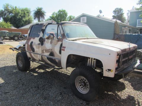 1987 Suzuki Samurai - This heavily modified truck features camouflage paint and the name 'Ol Rusty' on its side.