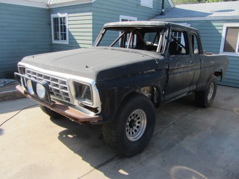 1987 Suzuki Samurai - This modified pickup truck appears to be undergoing some form of customization or restoration.
