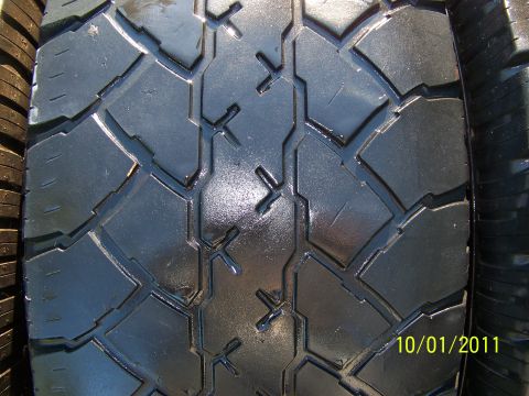 1986 Ford Bronco - A close-up view of a tire's tread pattern, with a date stamp visible in the lower right corner.