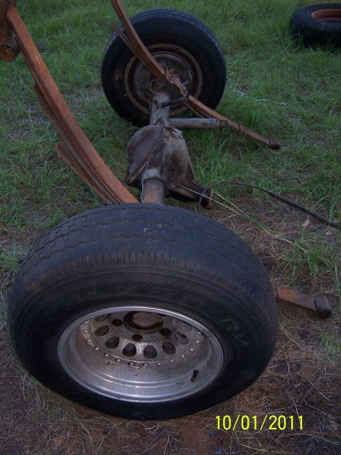 1986 Ford Bronco - Rear axle assembly with leaf springs and tires, likely from an older vehicle.