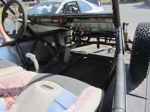 1987 Suzuki Samurai - The interior of a custom-built buggy shows its roll cage, racing seats, and manual transmission shifter.