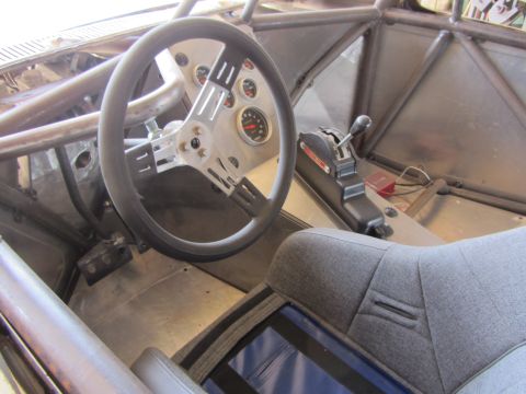1987 Suzuki Samurai - Interior view of a custom-built vehicle with a roll cage and racing seat.
