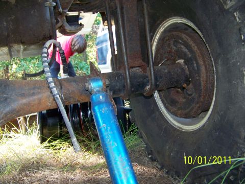 1986 Ford Bronco - Close-up view of the rear axle and suspension system of a vehicle.