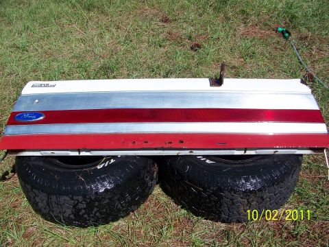1986 Ford Bronco - Tailgate from a 1986 Ford Bronco, red and silver accents and the iconic Ford emblem.