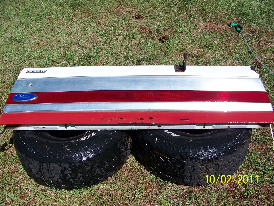 1986 Ford Bronco tailgate with red and silver trim and blue Ford badge
