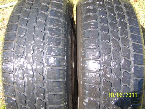 1986 Ford Bronco - Close-up of two tires with visible tread patterns and a date stamp.