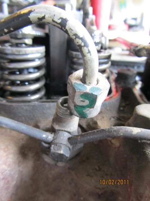 1984 Ford Bronco - Detail of engine components, including fuel lines and springs, with visible green markings.