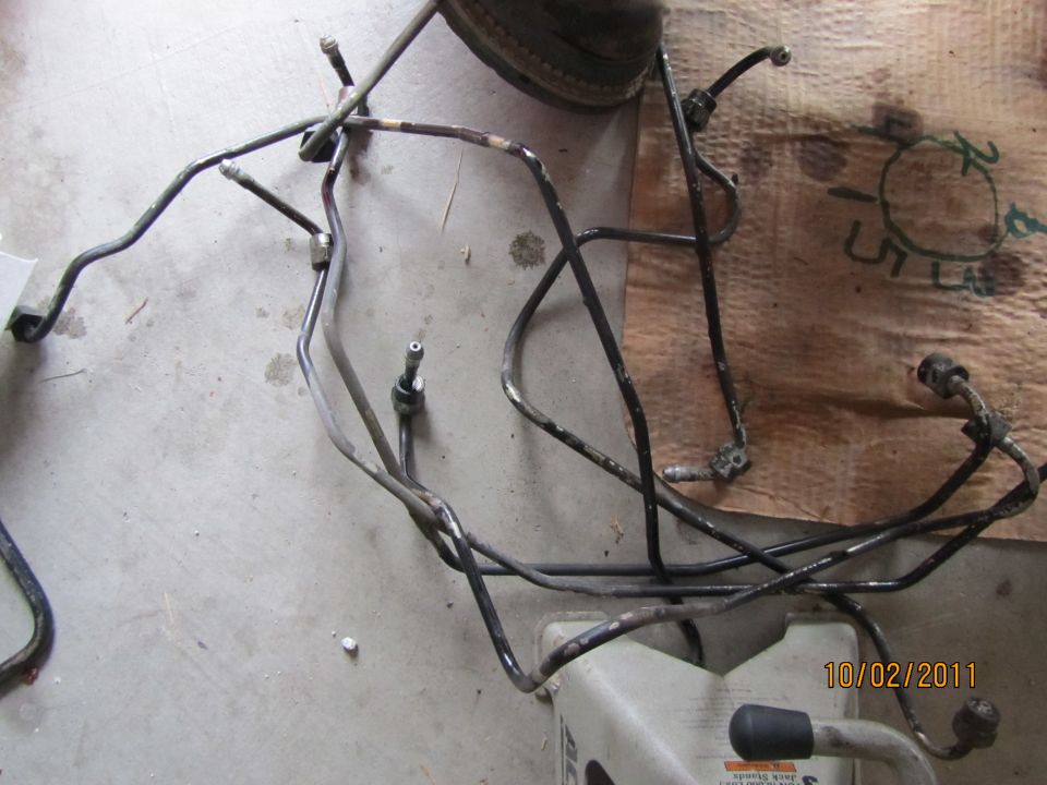 Bundle of metal brake lines on a concrete floor