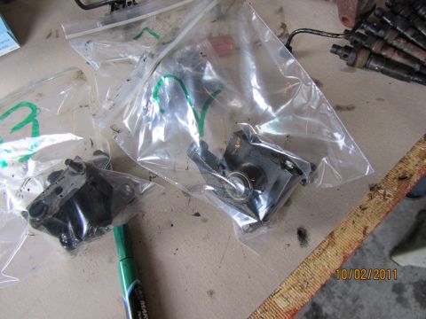 1984 Ford Bronco - Several engine components are bagged and organized on a surface, alongside a marker and a file.