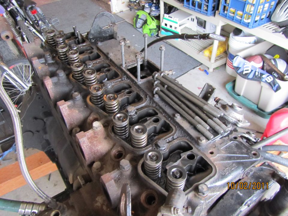 Engine block with valves and springs visible, date stamp 10/02/2011