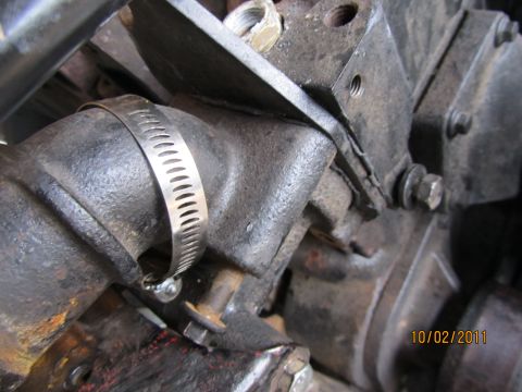 1984 Ford Bronco - Close-up view of an engine component with a metal hose clamp and visible bolts, dated 10/02/2011.