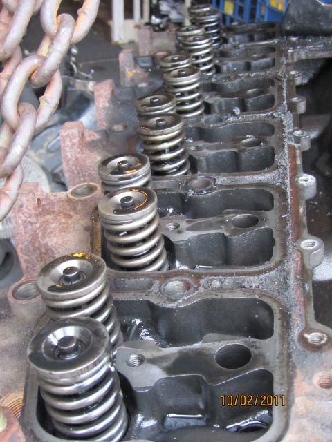 1984 Ford Bronco - Close-up of engine cylinder head components, showing valve springs and a metal chain.