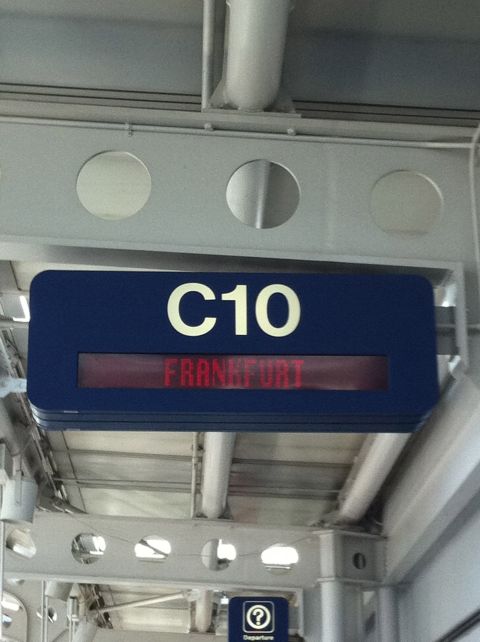 1987 Suzuki Samurai - A digital display board indicates gate C10 with Frankfurt as the destination.
