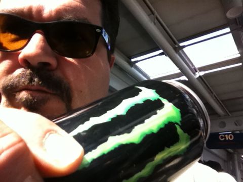 1987 Suzuki Samurai - A man holds a Monster Energy drink can in front of a ceiling with lights and a C10 sign.