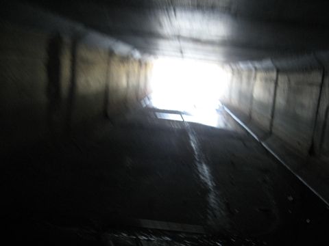 1994 Ford Bronco - The view from inside a dark tunnel looking towards a bright exit, with wet surfaces visible.