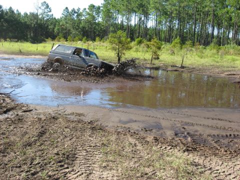 1994 Ford Bronco - This 1994 Ford Bronco navigates a muddy obstacle course, kicking up water and dirt.