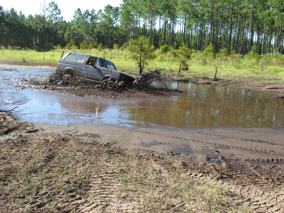 Gray 1994 Ford Bronco stuck in mud puddle, off-roading