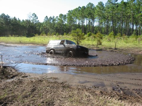 1994 Ford Bronco - Ford Bronco navigating a challenging muddy terrain.