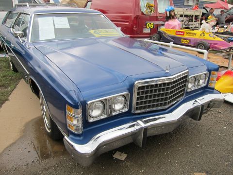 1991 Ford LTD Crown Victoria - A blue station wagon with a prominent chrome grille and bumper is displayed outdoors.