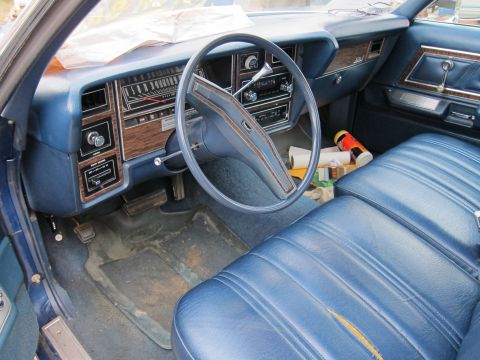 1991 Ford LTD Crown Victoria - The interior of this classic Ford sedan features blue vinyl seats and wood-grain trim on the dashboard and door panels.